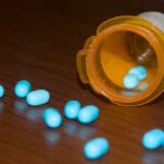 Image of pills spilling from a prescription bottle indicative of aging addicts.