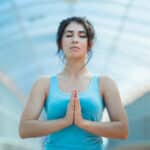 Photograph of a woman performing breathing exercises to manage stress.