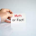 Photo of a hand holding a sign reading "myth or fact!"