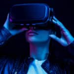 Photo of a woman in virtual reality glasses watching video with a virtual reality headset