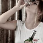 Photo of a woman portraying a sexual abuse survivor suffering from alcohol use disorder.