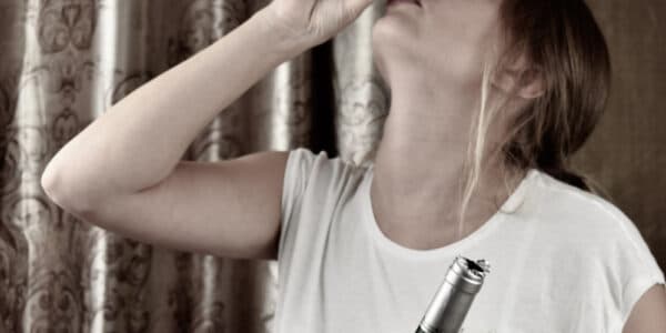 Photo of a woman portraying a sexual abuse survivor suffering from alcohol use disorder.