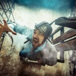Photo of an actor in a suit in an electric chair showing the power of fantasizing about revenge.