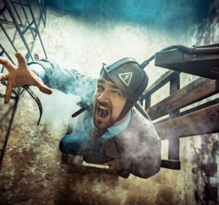 Photo of an actor in a suit in an electric chair showing the power of fantasizing about revenge.