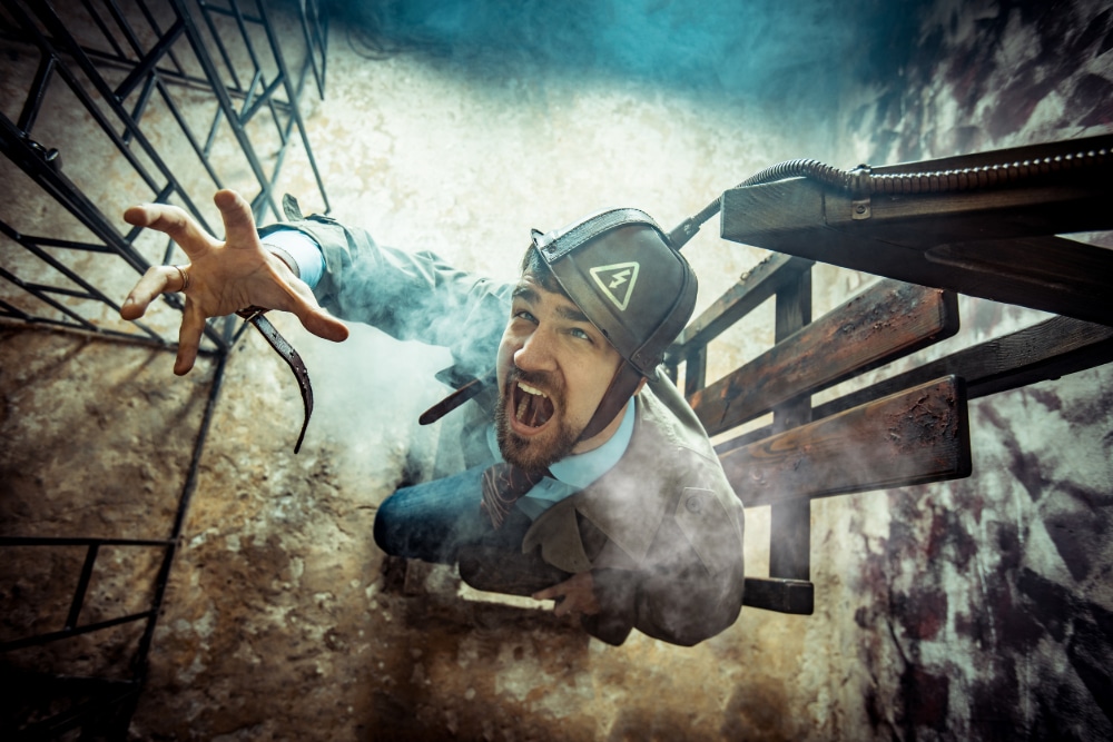 Photo of an actor in a suit in an electric chair showing the power of fantasizing about revenge.