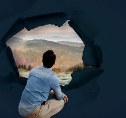 Surreal image includes photo of a man crouching down and looking out through a 360-degree window at a beautiful landscape representing addiction recovery.