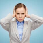 Photo of robotic-looking woman with her hands over her ears and an expression indicating cognitive dissonance.