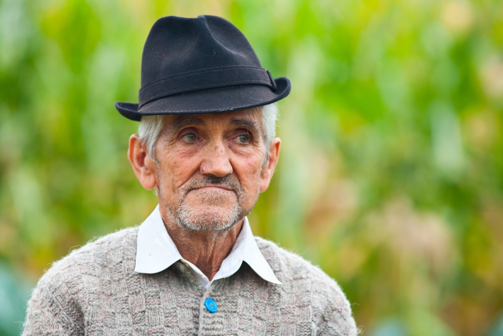 Photo of an elderly man in wearing a sweater.