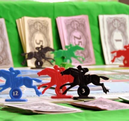 Plastic horses arranged in a race, with the piles of fake money in the background.