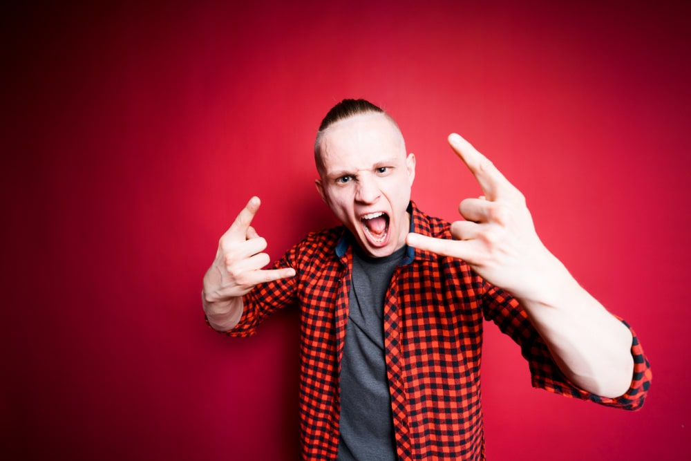 photograph of an angry young man displaying signs of neuroticism.