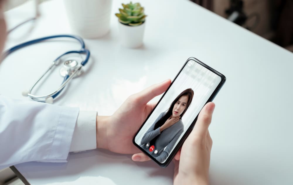 Photograph of a patient using an addiction recovery app to communicate with a medical professional.