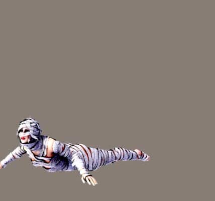 A woman crawling and wearing bandages all over her body like a mummy.