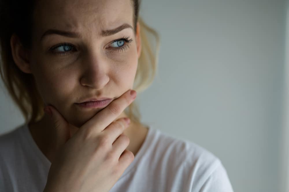 Photograph of a woman showing signs of anxiety.