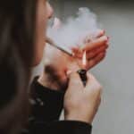 A woman smoking a cigarette.