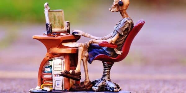 A skeleton sitting at the desk