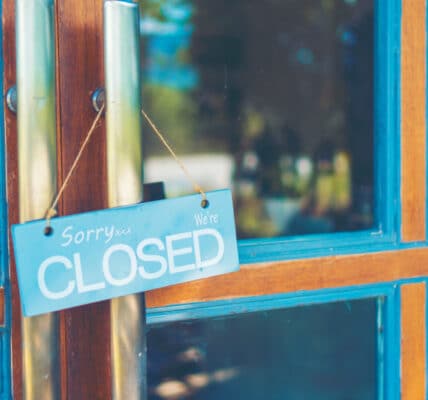 Photograph of a business door with a CLOSED sign, indicating the closure of eating disorder clinics.