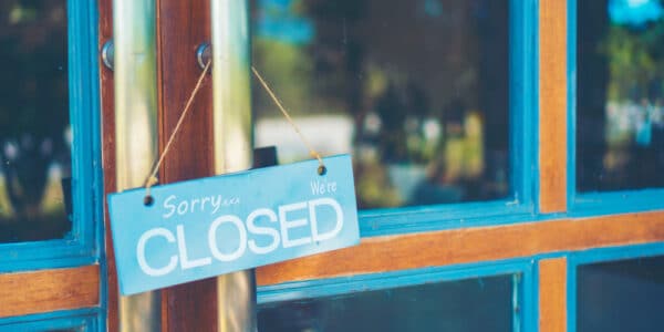 Photograph of a business door with a CLOSED sign, indicating the closure of eating disorder clinics.