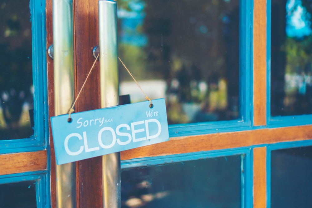 Photograph of a business door with a CLOSED sign, indicating the closure of eating disorder clinics.