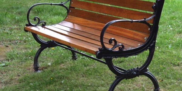 Photo of an empty park bench, symbolic of luring the homeless off park benches with affordable housing.