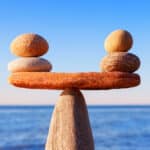 Photograph of stones perfectly balanced as a metaphor for transfer addiction and the need to find safe substitute activities to displace stress.