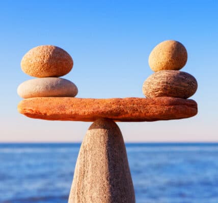 Photograph of stones perfectly balanced as a metaphor for transfer addiction and the need to find safe substitute activities to displace stress.