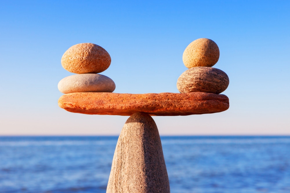 Photograph of stones perfectly balanced as a metaphor for transfer addiction and the need to find safe substitute activities to displace stress.