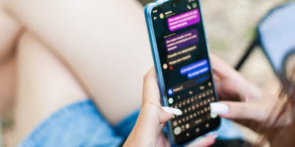 Photo of a young woman in dialogue with a AI chatbot.