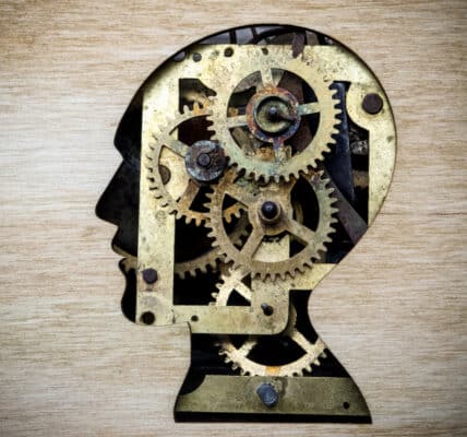 Illustration of a silhouette of the human head filled with gears, indicating the target of attentional bias modification.