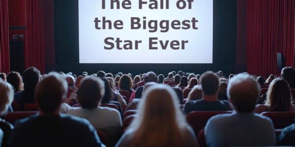 The view of the audience from the back and the screen that says, "The Fall of the Biggest Star Ever."