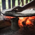 Photo of a hand over a hot fire, a metaphor for avoidance learning.