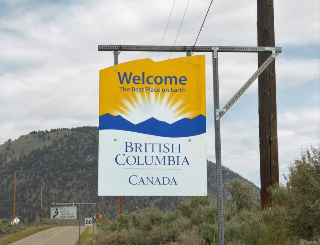 Photo of highway sign reading "Welcome to British Columbia Canada" and "The Best Place on Earth"