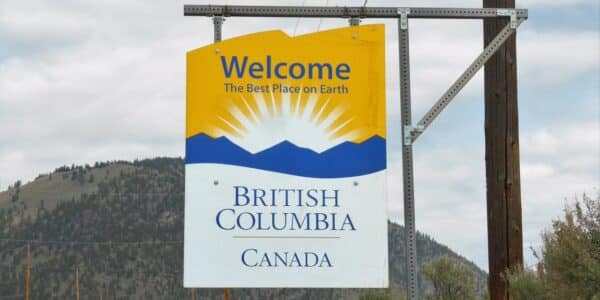 Photo of highway sign reading "Welcome to British Columbia Canada" and "The Best Place on Earth"