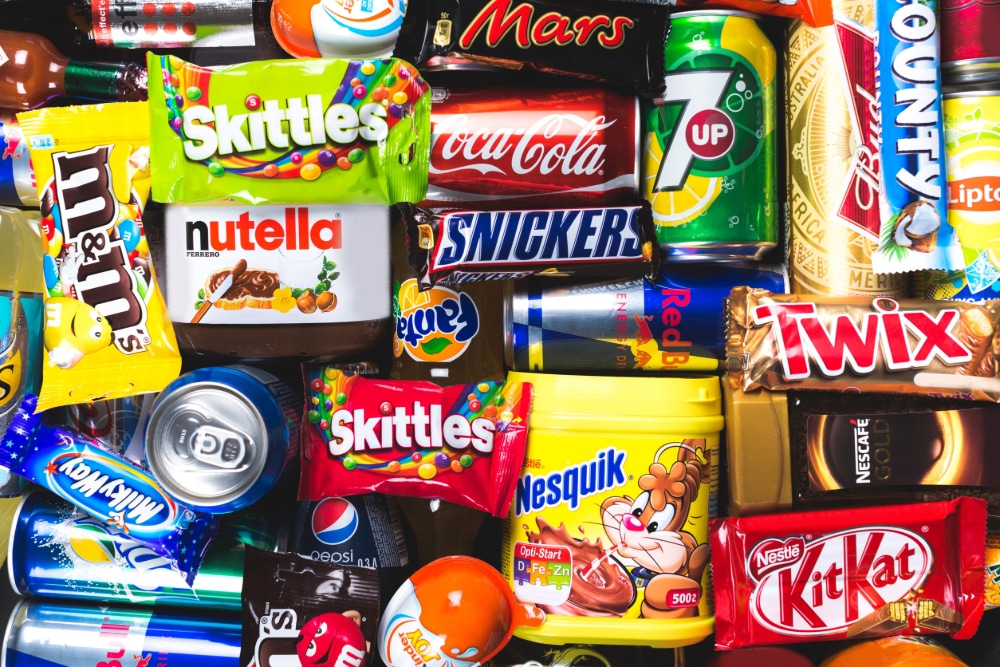 Photograph of ultra-processed junk food snacks in their original packaging.