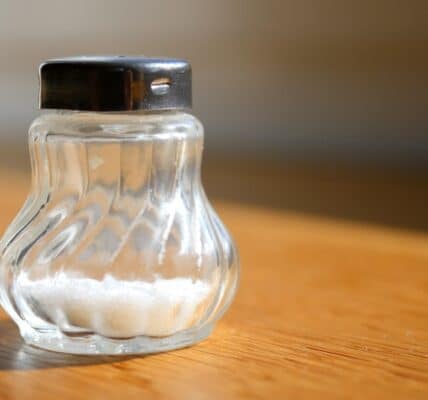 A photo of a salt shaker on the table.
