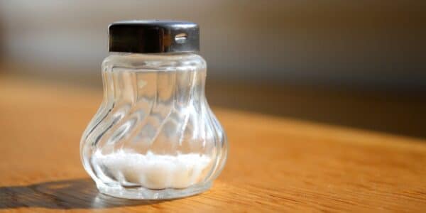 A photo of a salt shaker on the table.