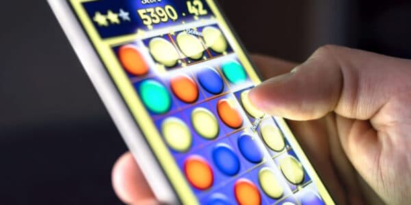 Up close photo of a hand playing a smartphone game.