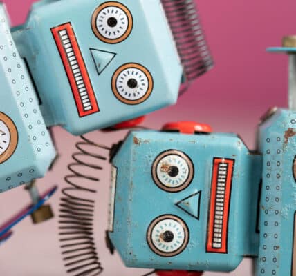 Photo of two vintage toy robots with distressed expressions.