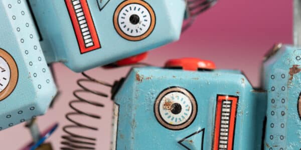 Photo of two vintage toy robots with distressed expressions.