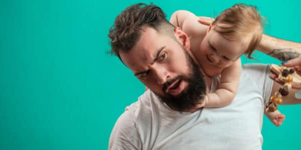 Photo of a father playing with a baby.