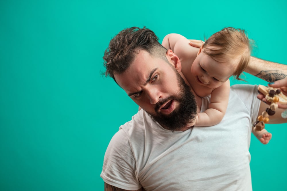 Photo of a father playing with a baby.