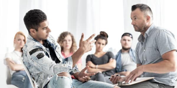 Group therapy session with teens being treated for smartphone addiction.