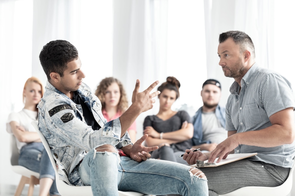 Group therapy session with teens being treated for smartphone addiction.