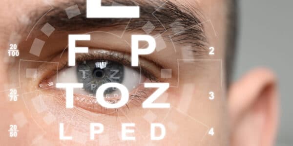 Photo of a woman's eye superimposed with an eye chart.