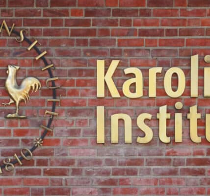 Photo of a brick wall containing the logo of the Karolinska Institutet.