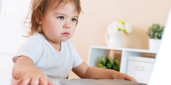 Photo of a child sitting in front of a computer.