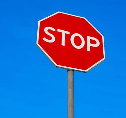 Stop sign against the blue sky.