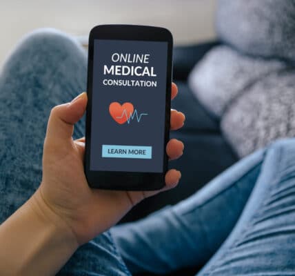 Photo of a person holding a smartphone that shows a screen offering an "Online Medical Consultation."