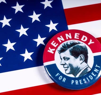 The "Kennedy for President" button set against the American flag.