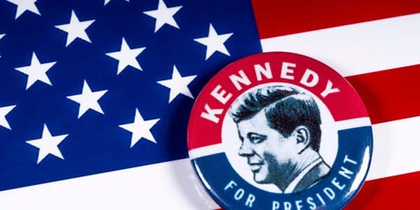 The "Kennedy for President" button set against the American flag.